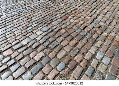 Tiles texture. Pattern of ancient german cobblestone in city downtown. Little granite paving stones. Antique gray pavements.