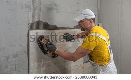 Tiling with large format tiles. A tiler expelling air from under the tile by a vibration suction cup.