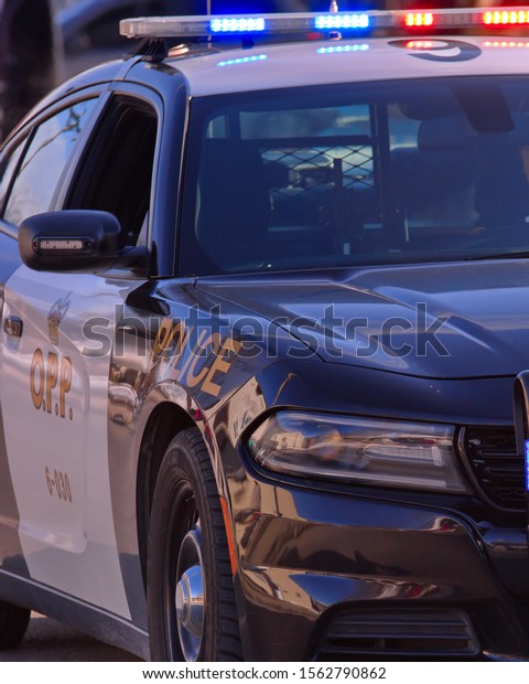 Tillsonburg, Ontario / Canada - November
16 2019 : Showing the passenger side of a modern Ontario Provincial
Police cruiser with overhead emergency lights
flashing.