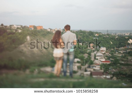 tilt shift and motion effect. couple in love on Valentine's day walking in a summer Park on a Sunny day. a romantic date on February 14. relationships of teenagers. emotional portrait of students