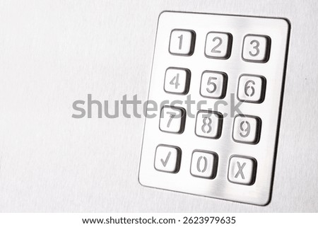 Tilted metallic numeric keypad panel