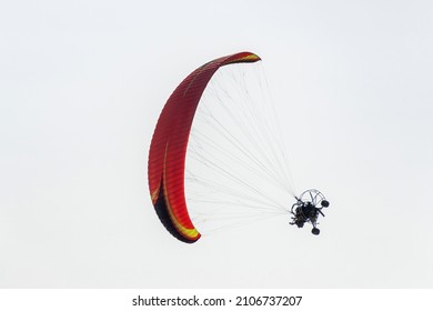 Tilted paramotor vehicle for flying around in a clear sky. Concept of powered parachute or powered paraglider.