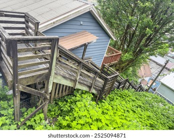 Tilted view of a backstreet shortcut, a steep stairway from a street high in a residential neighborhood to a lower street, in Juneau, Alaska, on a spring morning. Motifs of pedestrian infrastructure. - Powered by Shutterstock