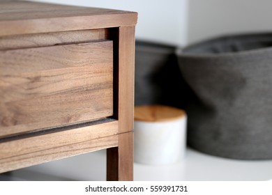 Timber Bedside Table With Fabric Storage Tubs And Marble Storage Box In A Bedroom