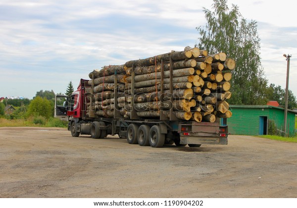 timber\
carrying vessel loaded felled trees in a\
beams.