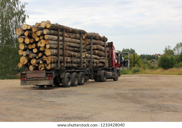 timber\
carrying vessel loaded felled trees in a\
beams.