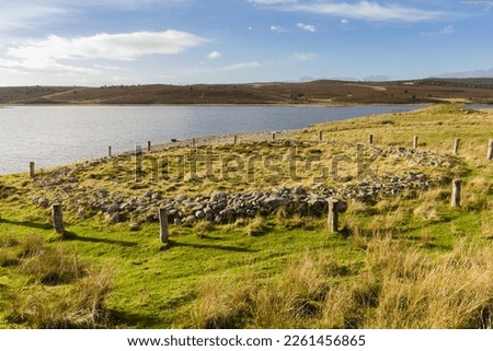Timber circle or ring cairn or Brenig 44 with the burial mound Boncyn Arian or Brenig 45 behind it. Dated to 2000 - 1500 BC and located at Llyn Brenig reservoir in the Denbigh moors Wales