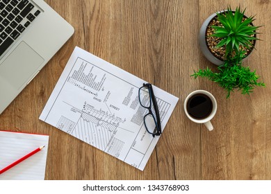 Timber Desktop Office With Laptop, Camera, Glasses, Pot Plants And A Cup Of Coffee. Top View With Copy Space For Text. Designer Workspace On Desk Table.