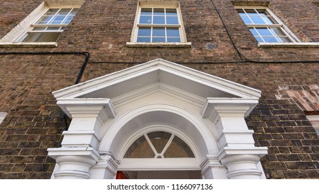 Timber Door Pediment Against Red Brick Georgian Building, Low Angle Taunton Somerset Summer 2018