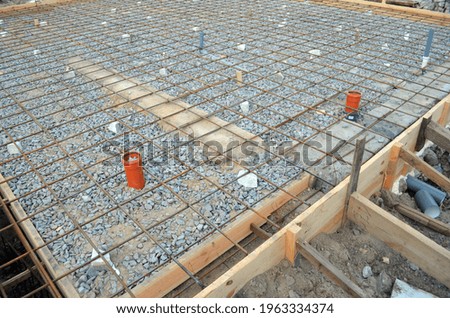 Timber formwork with metal reinforcement for pouring concrete and creating a solid foundation for a building or fence. Construction process.
