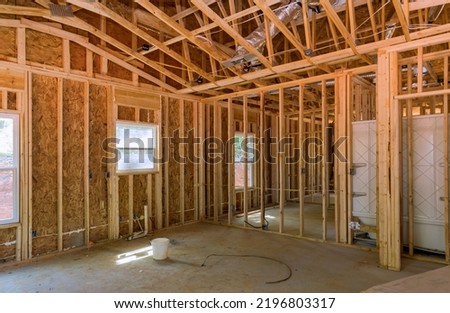 Timber frame beam framework house stick built home under construction new build with wooden truss