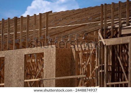 Timber Frame House. Constructing new timber framed houses in America. Timber Canadian Log Home or Timber Finnish Log House with OSB Sheathing. Contemporary ecological construction.