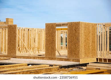 Timber frame house wooden beams with OSB (Oriented Strand Board) plywood sheathing residential home under construction suburbs Atlanta, Georgia, USA. Suburban American building new development - Shutterstock ID 2358736951