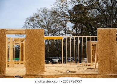 Timber frame house wooden beams with OSB (Oriented Strand Board) plywood sheathing residential home under construction suburbs Atlanta, Georgia, USA. Suburban American building new development - Shutterstock ID 2358736957