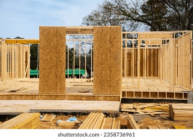 Timber frame house wooden beams with OSB (Oriented Strand Board) plywood sheathing residential home under construction suburbs Atlanta, Georgia, USA. Suburban American building new development - Shutterstock ID 2358736961