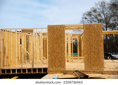 Timber frame house wooden beams with OSB (Oriented Strand Board) plywood sheathing residential home under construction suburbs Atlanta, Georgia, USA. Suburban American building new development - Shutterstock ID 2358736963