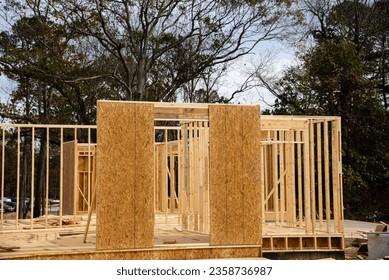 Timber frame house wooden beams with OSB (Oriented Strand Board) plywood sheathing residential home under construction suburbs Atlanta, Georgia, USA. Suburban American building new development - Shutterstock ID 2358736987