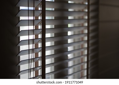 Timber Venetian Blinds On Window Casting Shadows