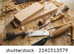 Timber, wood processing. Joinery work. Wood carving with work tools close up. Hand of carver carving wood. Craftsman carving with a gouge