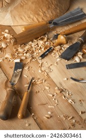 Timber, wood processing. Joinery work. Wood carving with work tools close up. Hand of carver carving wood. Craftsman carving with a gouge