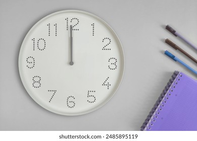 Time 12 o'clock or Noon. Clocks and office supplies on light gray background. Coffee break, lunch break, study break. Theme of class schedule, to-do list, time management - Powered by Shutterstock