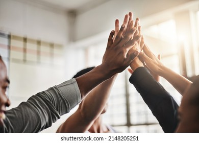 Time to bring our best. Shot of a group of young people giving each other a high five during their workout in a gym. - Powered by Shutterstock