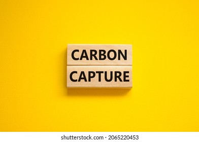 Time to carbon capture symbol. Wooden blocks with words 'Carbon capture'. Beautiful yellow background. Business, ecology and carbon capture concept. Copy space.