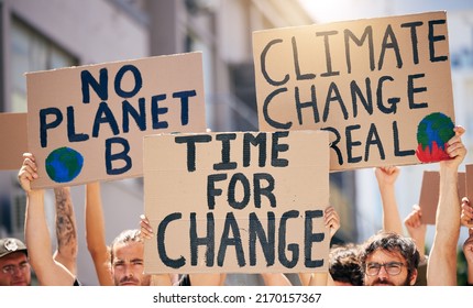 The Time For Change Is Now. Shot Of A Group Of People Holding Up Signs At A Protest Rally.