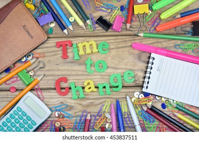 Time to Change text and office tools on wooden table