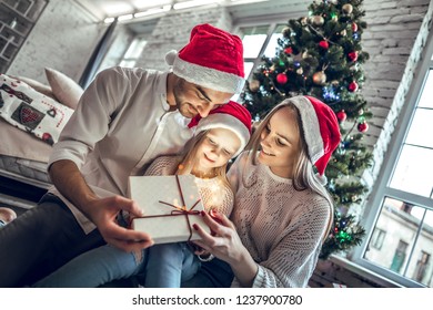 It's Time To Christmas Magic. Happy Family Looking Inside Of Magic Christmas Gift Box.