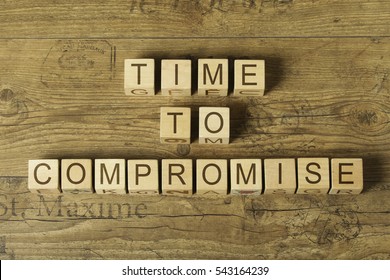 time to compromise text on cubes on wooden background