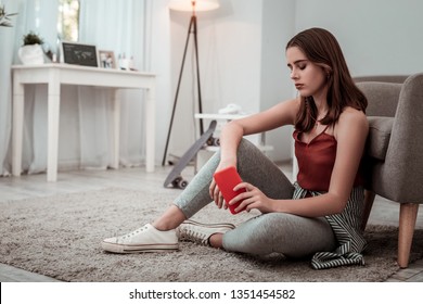 Time for concentration. A thoughtful girl listening to music at home