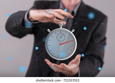 Time concept between hands of a man in background