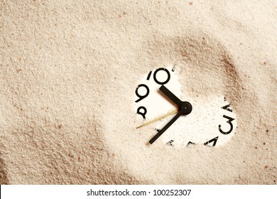 Time Concept. Sand Background With Clock Face