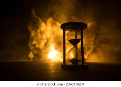Time concept. Silhouette of Hourglass clock on dark toned background. Abstract concept with copy space. Selective focus