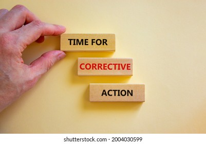 Time for corrective action symbol. Wooden blocks with words 'Time for corrective action' on a beautiful white background. Businessman hand. Business, time for corrective action concept. Copy space.