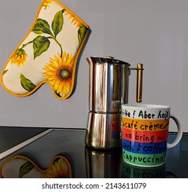 Time For A Cup Of Coffee - Designer Coffee Mug With Vintage Stovetop Espresso Maker On A Modern Stove.