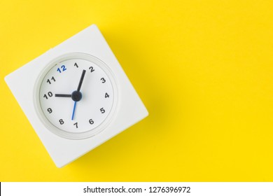 Time, Deadline Or Reminder And Schedule Concept, Minimal Modern Square Alarm Clock With White Face On Yellow Background In Flat Lay Or Top View, Studio Shot With Copy Space.