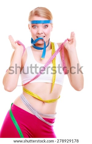 Time for diet slimming weight loss. Health care healthy lifestyle. Fit fitness woman with a lot of colorful measure tapes. Obsessed girl by her body.