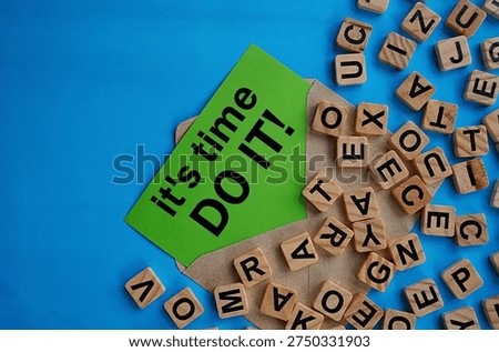 It's time, do it note in a gray envelope and a scattering of wooden letter blocks, self-development concept, act immediately, don't delay