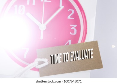 TIME TO EVALUATE CONCEPT: Red clock and bookmark.