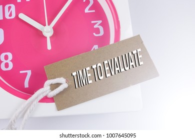 TIME TO EVALUATE CONCEPT: Red clock and bookmark.