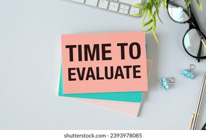TIME TO EVALUATE text concept write on notebook with office tools on the white background