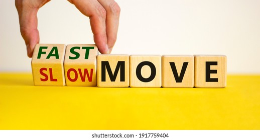 Time to fast move symbol. Businessman turns a wooden cube and changes words 'slow move' to 'fast move'. Beautiful yellow table, white background, copy space. Business and slow or fast move concept. - Shutterstock ID 1917759404