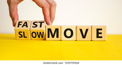 Time to fast move symbol. Businessman turns a wooden cube and changes words 'slow move' to 'fast move'. Beautiful yellow table, white background, copy space. Business and slow or fast move concept. - Shutterstock ID 1919759324