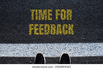 Time for feedback message written on asphalt road. Conceptual time for feedback symbol. Copy space.