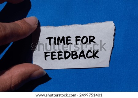 Time for feedback message written on ripped torn paper with blue background. Conceptual time for feedback symbol. Copy space.