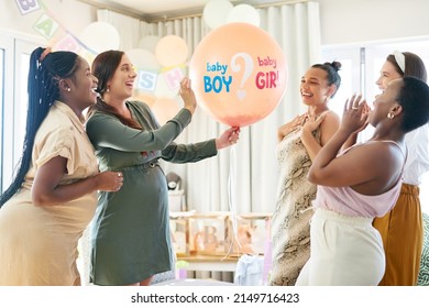 Time to find out. Shot of a group of women about to pop a balloon for a gender reveal during a baby shower. - Shutterstock ID 2149716423