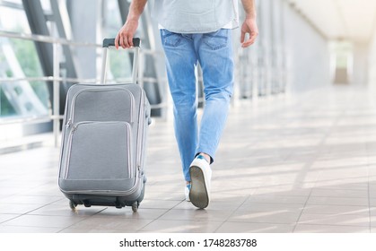 Time To Flight. Unrecognizable Man Walking With Suitcase In Airport, Going To Boarding Gate, Cropped Image, Rear View