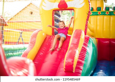  Time for fun. Little girl playing in playground and sliding. Space for copy. - Shutterstock ID 1195485469